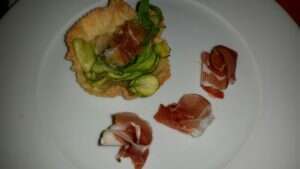 Tartelette di pate brisée al burro con cipolla e zucchine al pepe verde e maggiorana con prosciutto crudo Tartelette di pate brisée al burro con cipolla e zucchine al pepe verde e maggiorana con prosciutto crudo